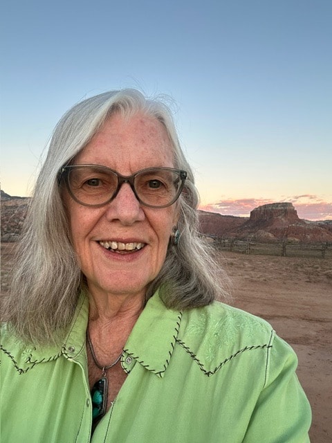 Kelly O. Finnerty smiling in the New Mexico high desert